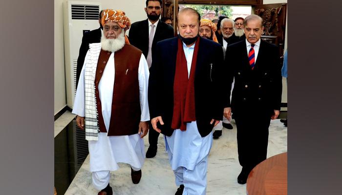 The Pakistan Muslim League Nawaz (PMLN) supremo Nawaz Sharif walks with JUIF chief Maulana Fazlur Rahman on December 4, 2023. — Facebook/PML(N)