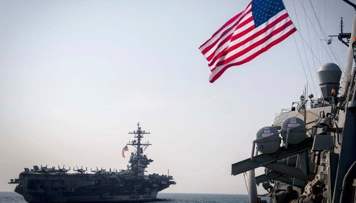 The US Navy aircraft carrier and a ship can be seen in this image. — AFP/File