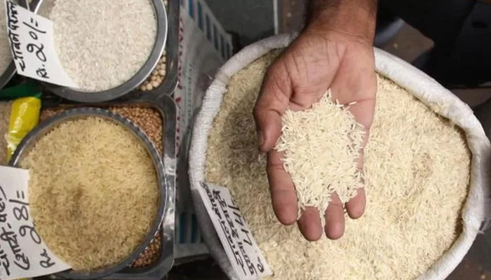 A representational image of a person showing rice. — AFP/File