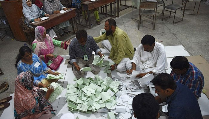 Election commission’s staffers count votes in Karachi. — AFP/File