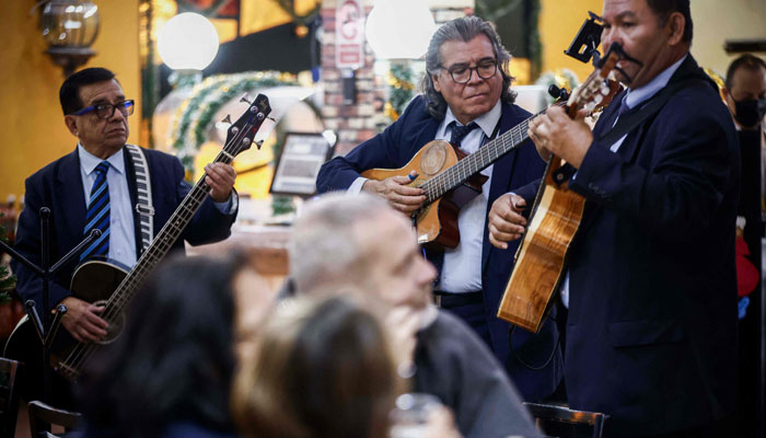 Mexican singers sing a bolero at a cantina in Mexico City on November 4, 2023.—AFP