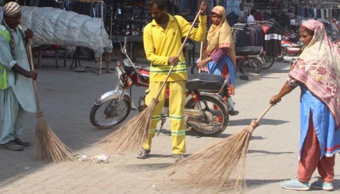 Lahore Waste Management Company (LWMC) workers can be seen cleaning the streets on October 18, 2023. — Facebook/Lahore Waste Management Company
