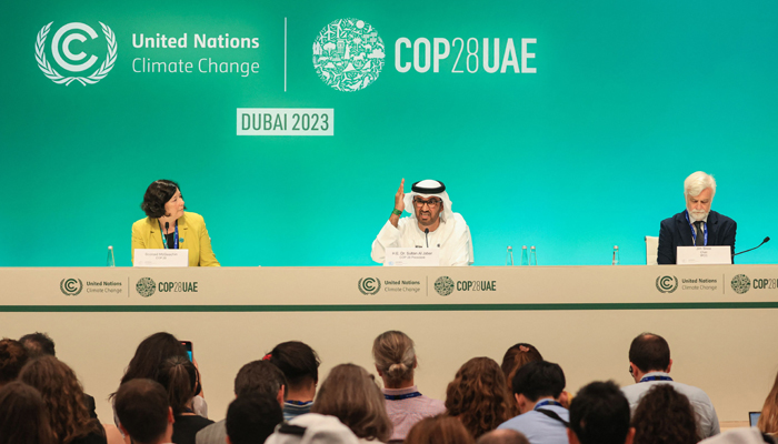 COP28 president Sultan Ahmed Al Jaber (C), Chair of the IPCC Jim Skea (R) and COP28 director of communications Sconaid McGeachin (L) attend a press conference at the United Nations climate summit in Dubai on December 4, 2023. — AFP