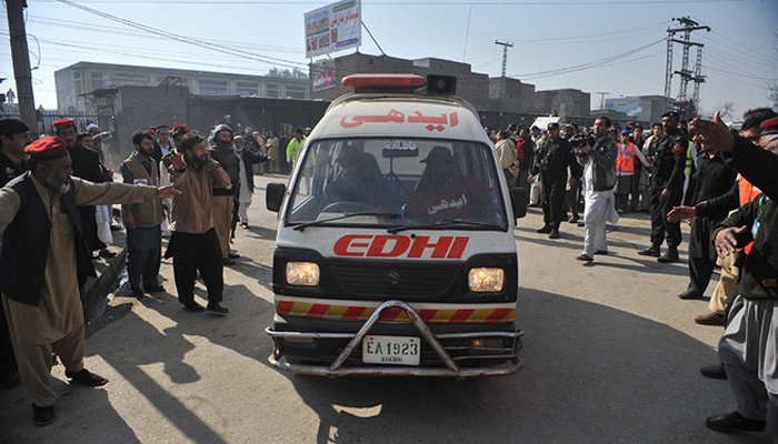 This representational image shows an ambulance arriving as surrounding people make their way. — AFP/File