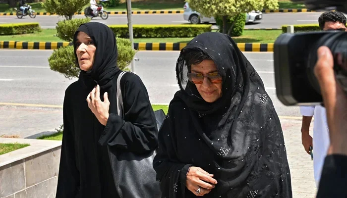 Aleema Khan (R) and Uzma Khanum, sisters of Pakistans former PM Imran Khan, arrive to attend the hearing at the High Court in Islamabad on August 25, 2023. — AFP