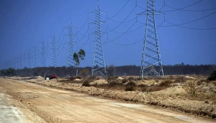 Power transmission poles in a rural area of Pakistan are seen in this photo. — AFP/File