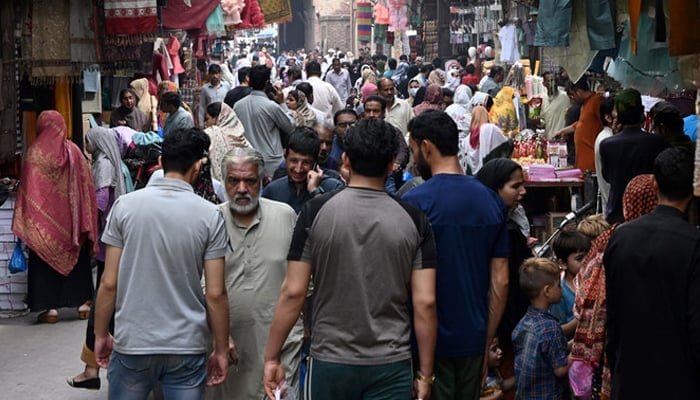In this picture taken on April 16, 2023, people throng a market area in Lahore. — AFP/File