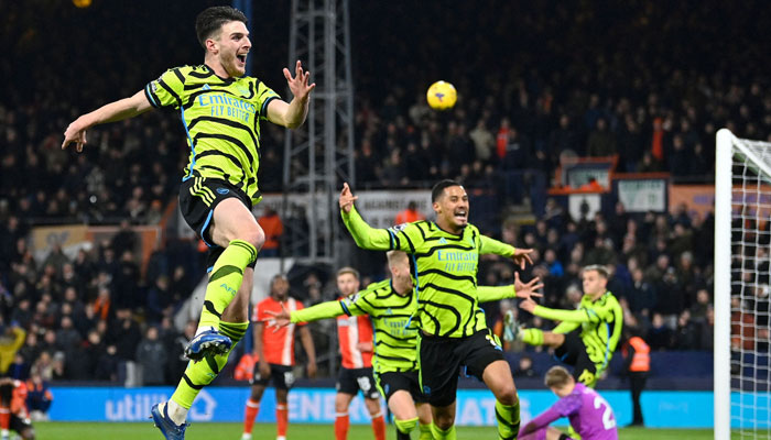 Declan Rice celebrates after scoring his teams fourth goal during the English Premier League football match between Luton Town and Arsenal at Kenilworth Road in Luton, north of London on December 5, 2023. — AFP