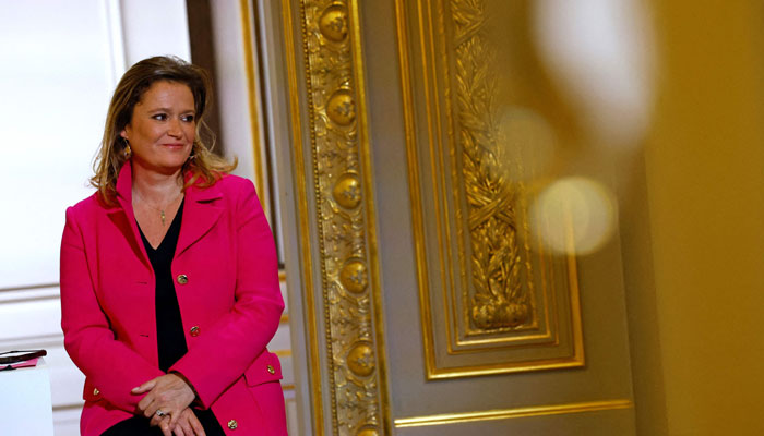 French Junior Minister, Olivia Gregoire listens to the speech of the French president during a meeting with heads of Small and Medium Enterprises, members of professional federations in Paris, on November 21, 2023. — AFP