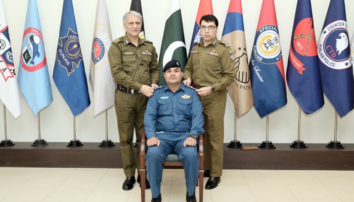 IGP Punjab and a senior police officer pin promotion rank on a traffic officer to the post of Senior Traffic Wardens on December 6, 2023. — Facebook/Punjab Police Pakistan