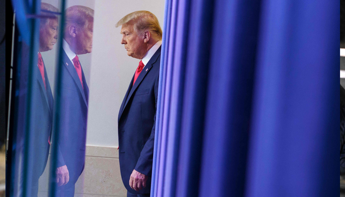 Former US President Donald Trump arrives to deliver remarks on the stock market during an unscheduled appearance in the Brady Briefing Room of the White House in Washington, DC on November 24, 2020. — AFP