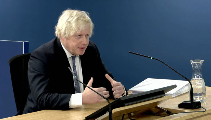 A video grab from footage shows Britains former PM Boris Johnson giving evidence at the UK Covid-19 Inquiry, in west London, on December 7, 2023. — AFP