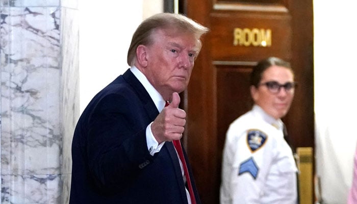 Former US President Donald Trump gestures as he returns from a break at the New York State Supreme Court during the civil fraud trial against the Trump Organization, in New York City on December 7, 2023. — AFP