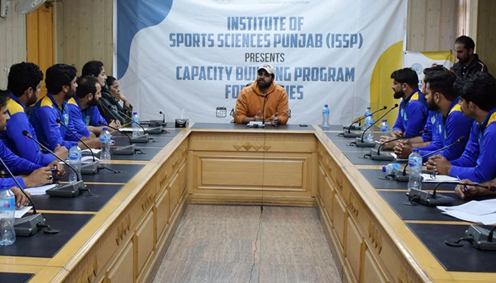 Participants listen as a trainer delivers a lecture on the significance of First Aid on the third day of the Punjab Institute of Sports Sciences training course at National Hockey Stadium on December 6, 2023. — Facebook/Sports Board Punjab