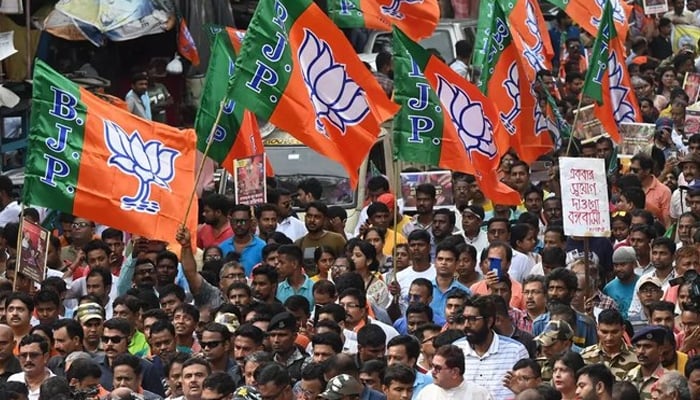 Bharatiya Janata Party (BJP) activists hold party flags during a rally in Kolkata, India, on July 19, 2023. — AFP