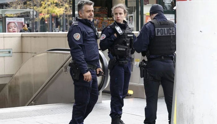 French police officers secure the Bibliotheque Francois Mitterrand RER and metro station on October 31, 2023. — AFP
