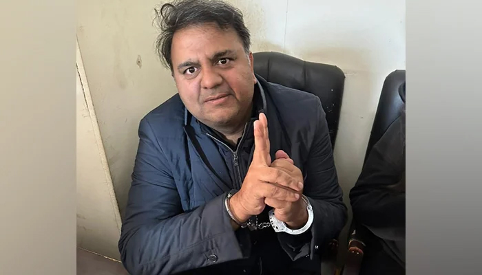 Former minister Fawad Chaudhry makes a victory sign as he is handcuffed by the police on January 27, 2023. — Facebook/Chaudhry Fawad Hussain