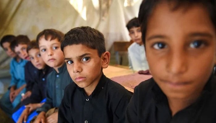 Students can be seen looking toward a camera in this image. — AFP/File