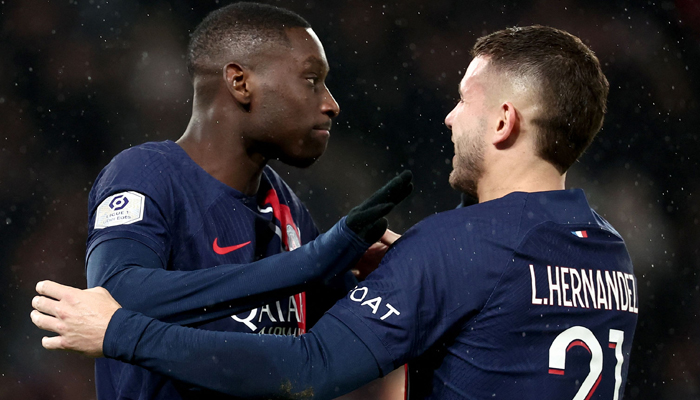 Paris Saint-Germains Randal Kolo Muani (L) is congratulated by PSGs Lucas Hernandez (R) after scoring a goal during the French L1 football match between Paris Saint-Germain (PSG) and Nantes at the Parc des Princes stadium on December 9, 2023 in Paris. — AFP