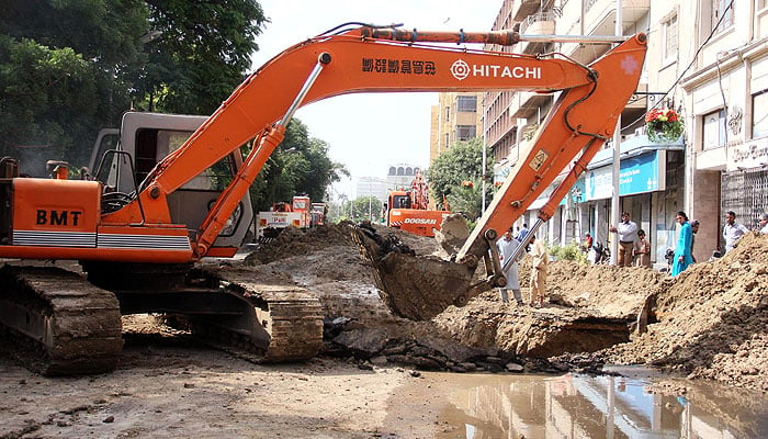 Workers are busy repairing sewerage lines with the help of heavy machinery on Club Road as after damaging of sewerage line. — Online/File