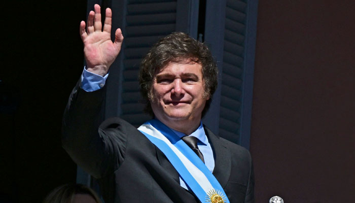 Argentinas new president Javier Milei waves at the crowd from a balcony of the Casa Rosada government palace during his inauguration day in Buenos Aires on December 10, 2023. — AFP