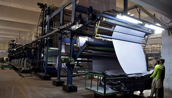 This image shows a worker in a factory. — AFP/File