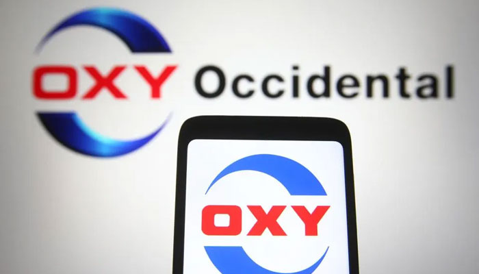 In this photo illustration, an Oxy (Occidental Petroleum Corporation) logo can be seen displayed on a smartphone and a PC screen. — SOPA