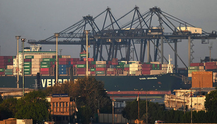 Shipping containers are seen stacked on a ship at a seaport in Karachi. — AFP/File