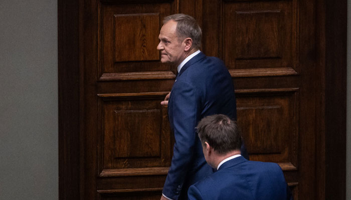 Donald Tusk leaves the parliament plenary hall after a vote over Tusk´s nomination to be the new Polish Prime minister in the Polish Parliament, Warsaw on December 11, 2023. — AFP