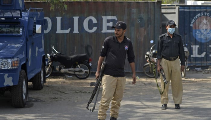 This image shows Sindh Police officials standing alert. — AFP/File