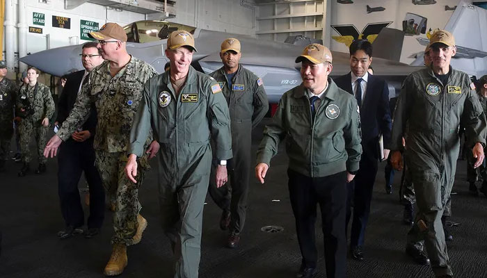 South Korean Defense Minister Shin Won-sik (2nd R) walks with US Navy Rear Admiral Carlos Sardiello (R) on the USS Carl Vinson, a US nuclear-powered aircraft carrier, during its port visit at a South Korean naval base in the southeastern port city of Busan on November 22, 2023.  . — AFP File