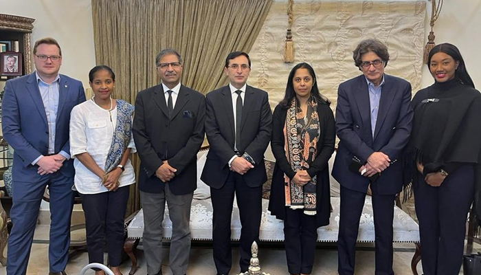 PTI Chairman Barrister Gohar Ali Khan (c) alongside other party officials poses for a group photo with the Commonwealth delegation on December 13, 2023. — Facebook/Pakistan Tehreek-e-Insaf