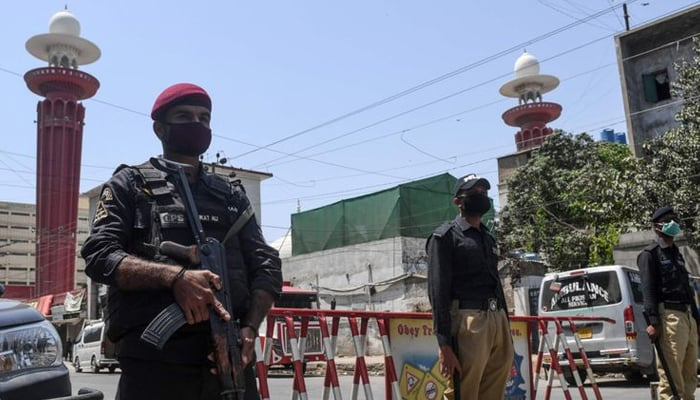 Sindh police personnel stand guard. — AFP/File