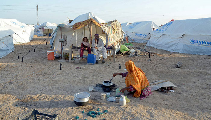A woman cooks food for her family at a camp in Sohbatpur, Jaffarabad district of Pakistans Balochistan province. — AFP/ File