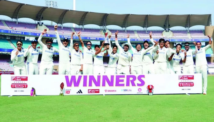 Indian players celebrate with the trophy after winning the one-off Test match for their first-ever win at home against England in Mumbai on Saturday. — BCCI