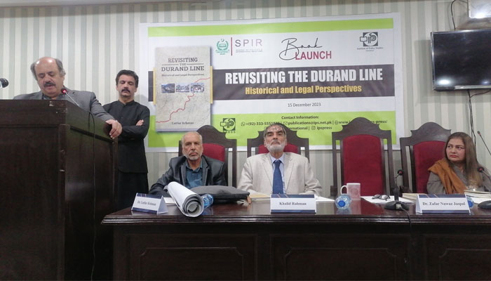 The image released on Dec 15, 2023 show the ceremony to launch a book ‘Revisiting the Durand Line: Historical and Legal Perspectives’ by Dr Lutfur Rehman. — x/QAU_SPIR