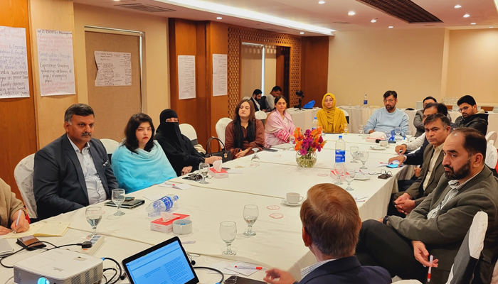 Officials look on as one of the participants addresses the member in this image during the First Meeting of Resilience Reference Group, as part of Strengthening Resilience and Reproductive Health Integration in Punjab on December 8, 2023. — Facebook/PPIF Punjab