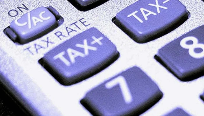 A representational image shows taxes written on the calculator keypads. — AFP/File