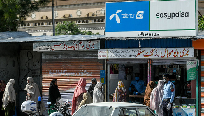 Women queue to collect cash through a mobile wallet in Islamabad. — AFP/File