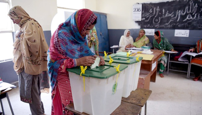 A woman casts her vote during general election at a polling station in Islamabad. — AFP/File