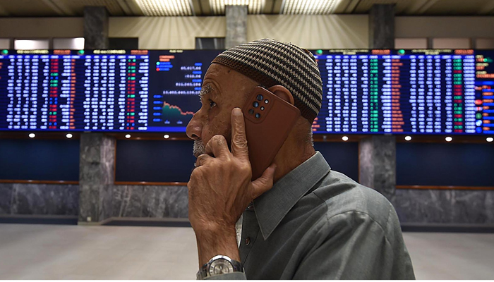 A stockbroker monitors the share prices during a trading session at the Pakistan Stock Exchange (PSX) in Karachi on December 18, 2023. — INP