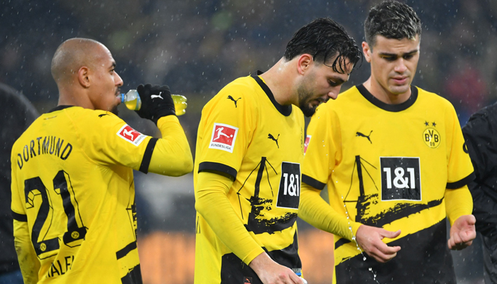 Dortmunds Donyell Malen, Ramy Bensebaini and Giovanni Reyna react after the German first-division Bundesliga football match between BVB Borussia Dortmund and Mainz 05 in Dortmund on December 19, 2023. — AFP