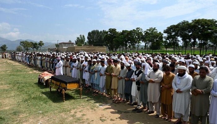 This picture shows people offering funeral prayers. — AFP/File