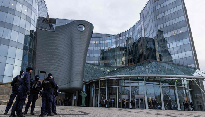 Police officers are seen in front of the headquarters of the Polish Public TV in Warsaw, on December 20, 2023. — AFP