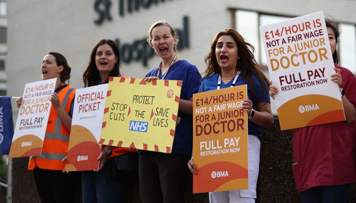 A group of doctors protesting low pay in England. — AFP