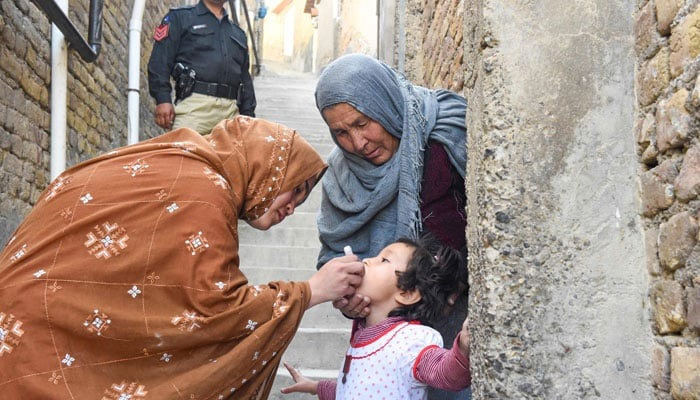 A health worker administers polio vaccine drops to a child during a vaccination campaign in Quetta. — AFP/File
