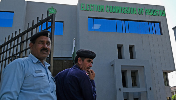 The Election Commission of Pakistan (ECP) building can be seen in the background of the security personnel. — AFP/File
