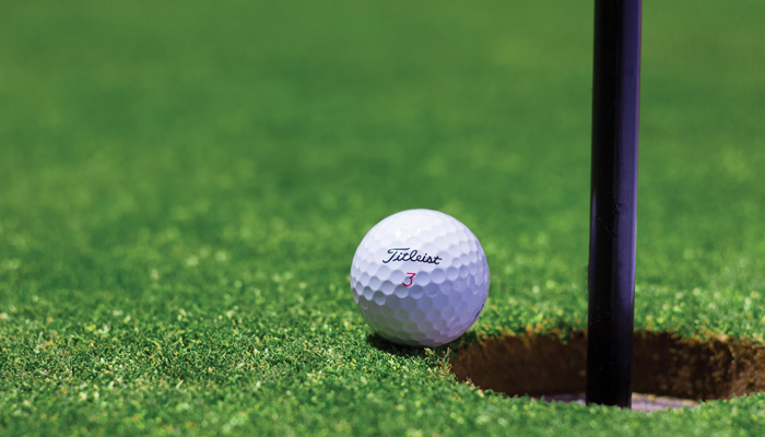 A representational image of a golf ball on a field. — Unsplash