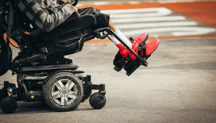 This representational image shows a disabled child sitting in an electric wheelchair. — Unsplash