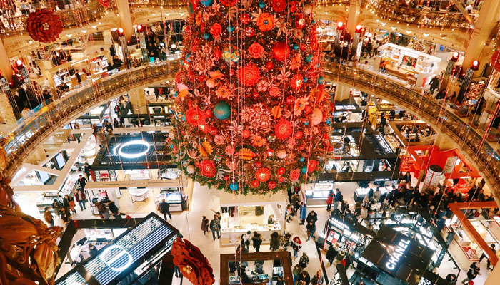 This representational image shows people walking around in a shopping mall. — Unsplash